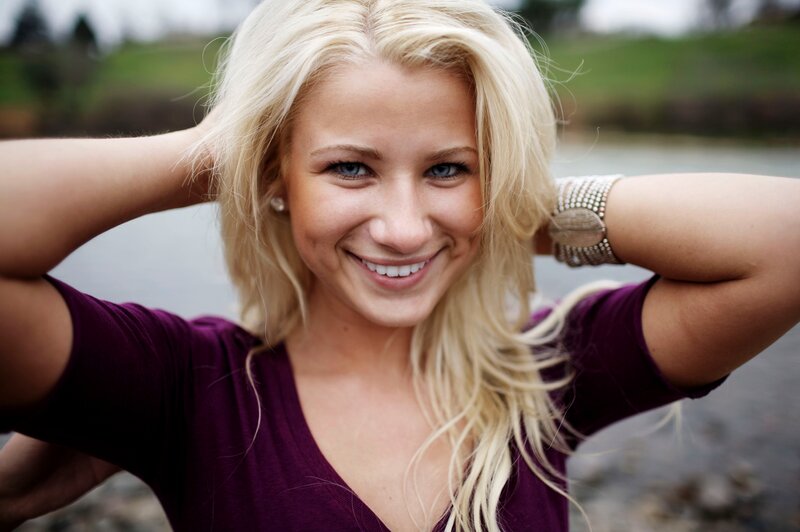blonde woman smiling outdoors