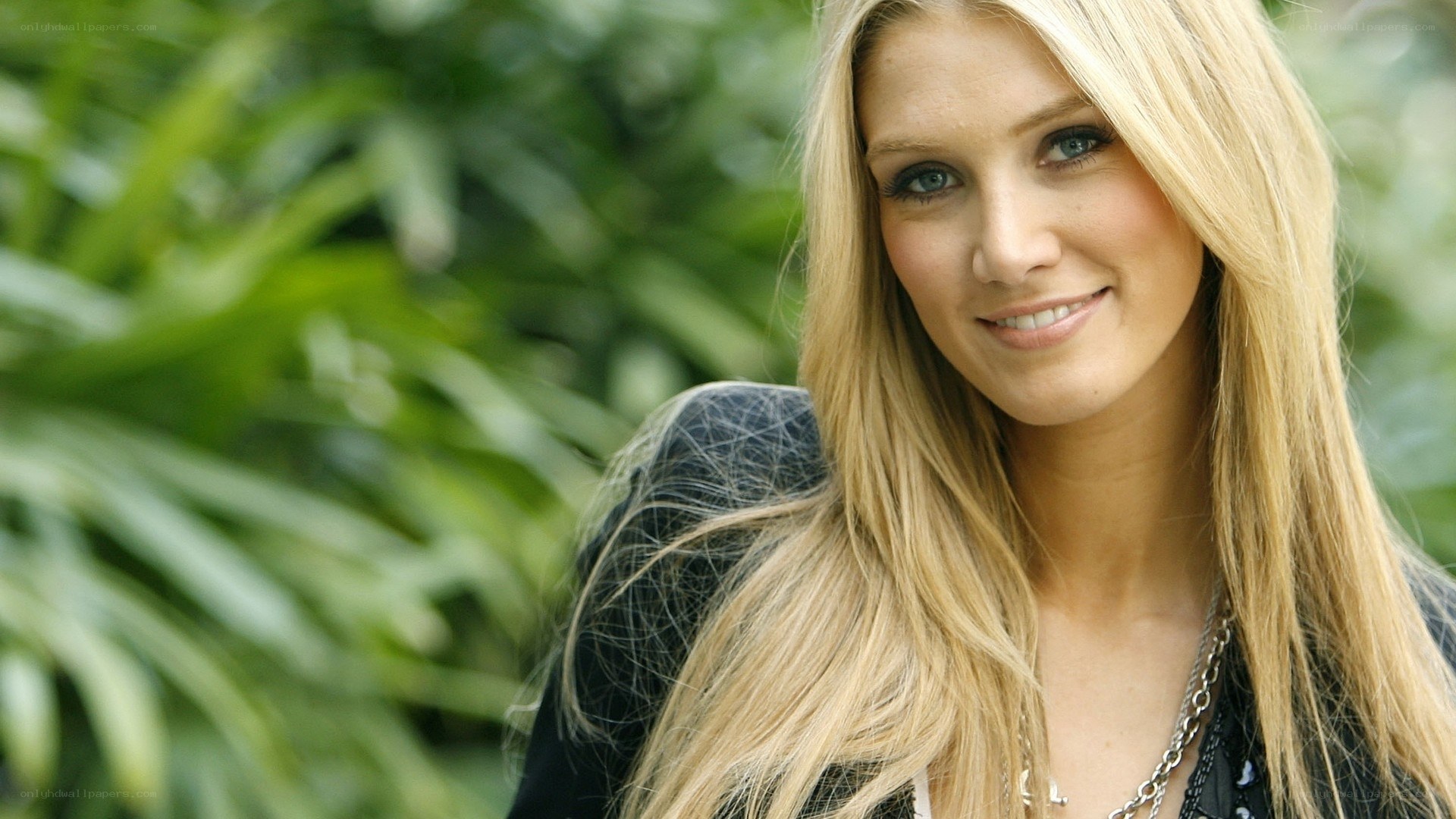 blonde woman smiling outdoors