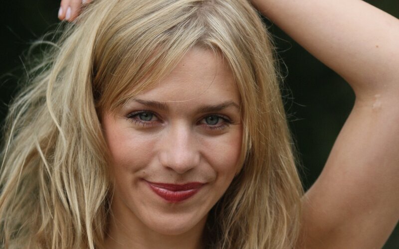 blonde woman smiling outdoors