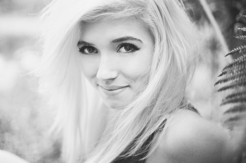 blonde woman smiling outdoors