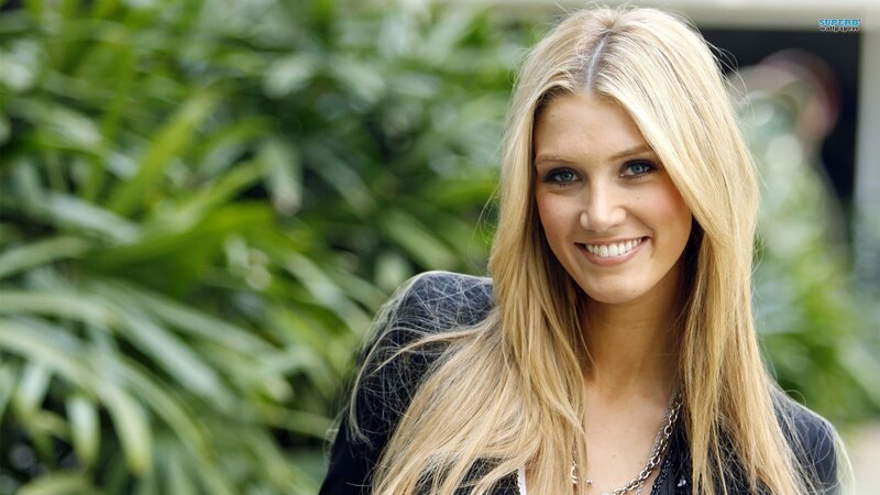 blonde woman smiling outdoors