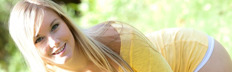 Blonde woman smiling outdoors
