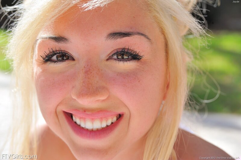 blonde woman smiling outdoors