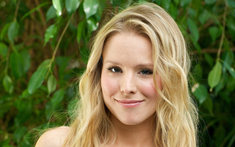 blonde woman smiling outdoors