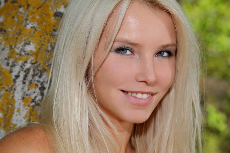 blonde woman smiling outdoors