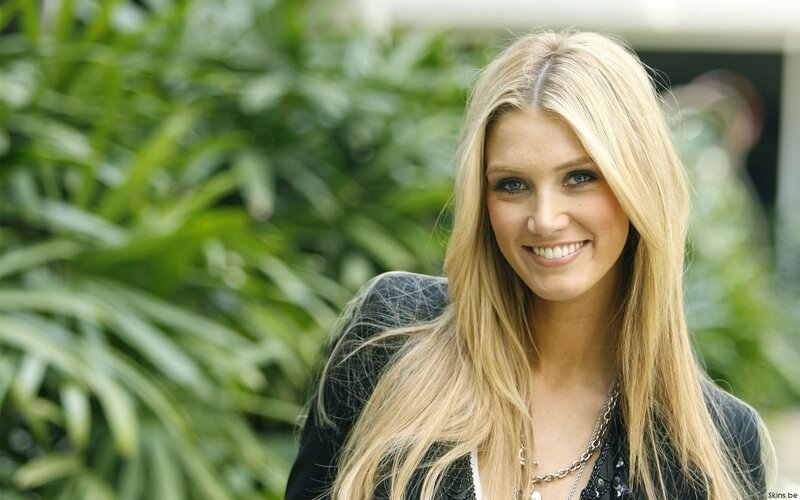 blonde woman smiling outdoors