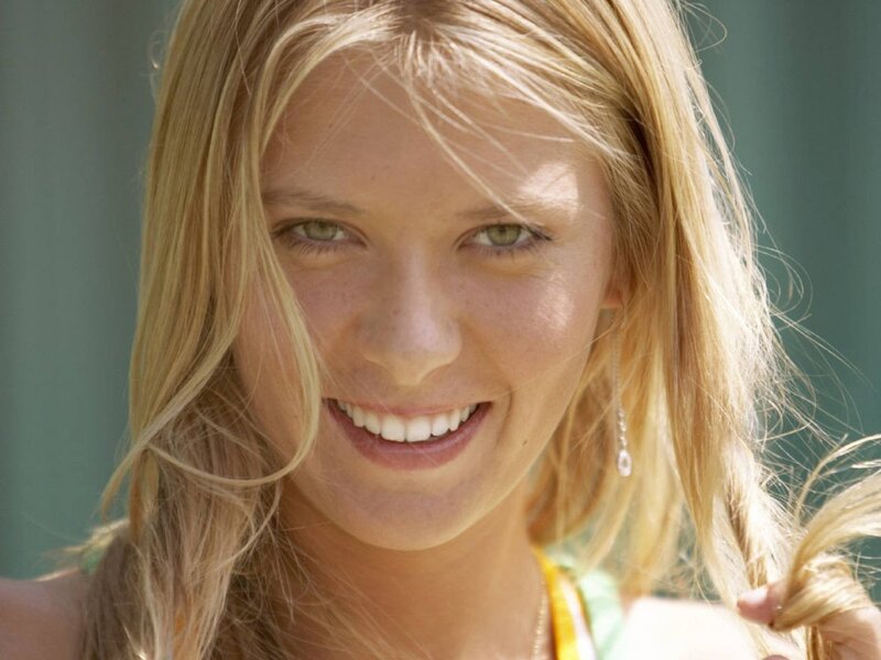blonde woman smiling outdoors