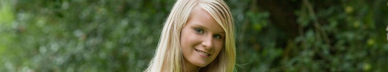 blonde woman smiling outdoors