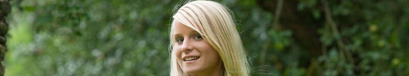 blonde woman smiling outdoors