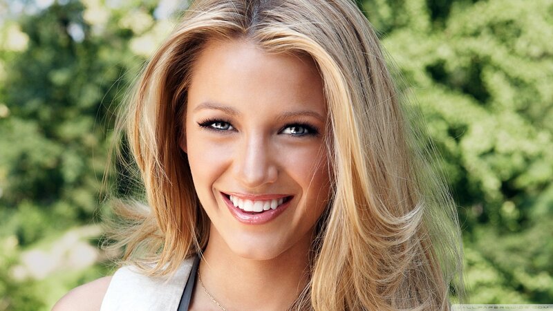 blonde woman smiling outdoors