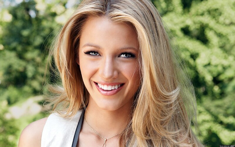 Blonde woman smiling outdoors