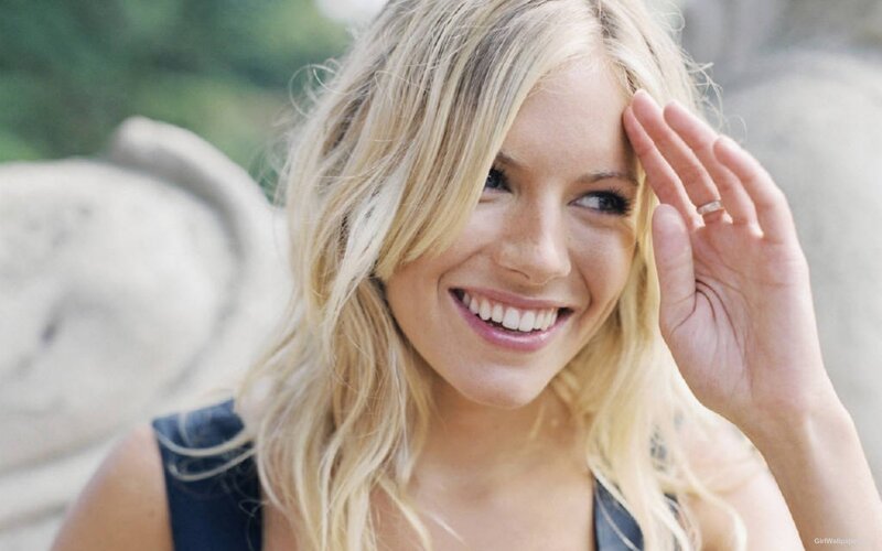 blonde woman smiling outdoors