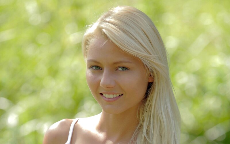 blonde woman smiling outdoors