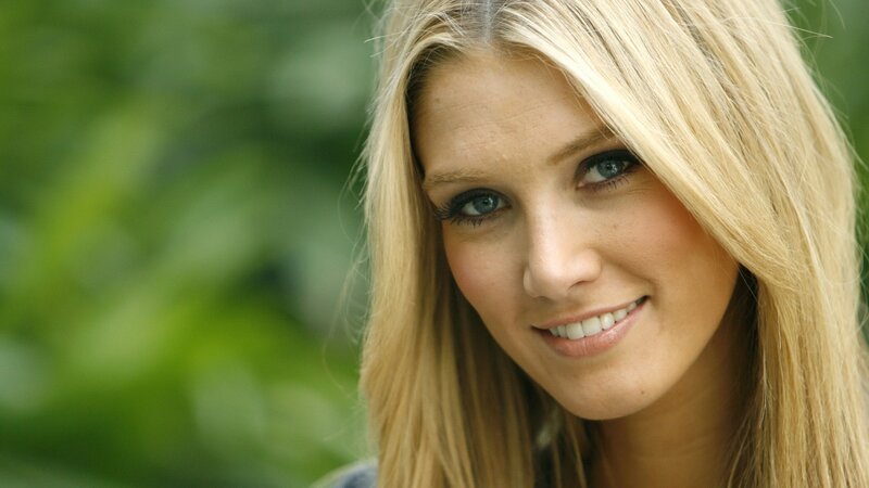 blonde woman smiling outdoors