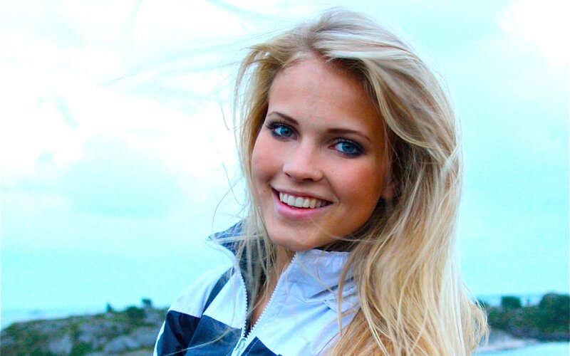 blonde woman smiling outdoors