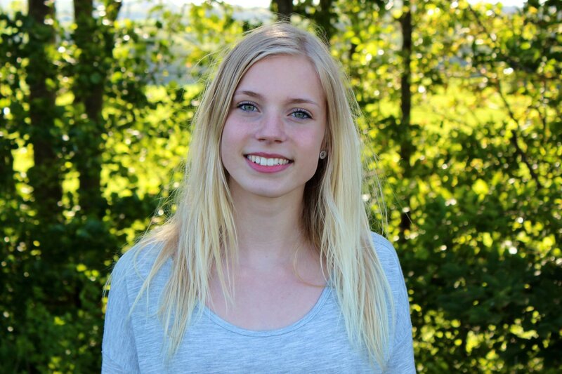 blonde woman smiling outdoors