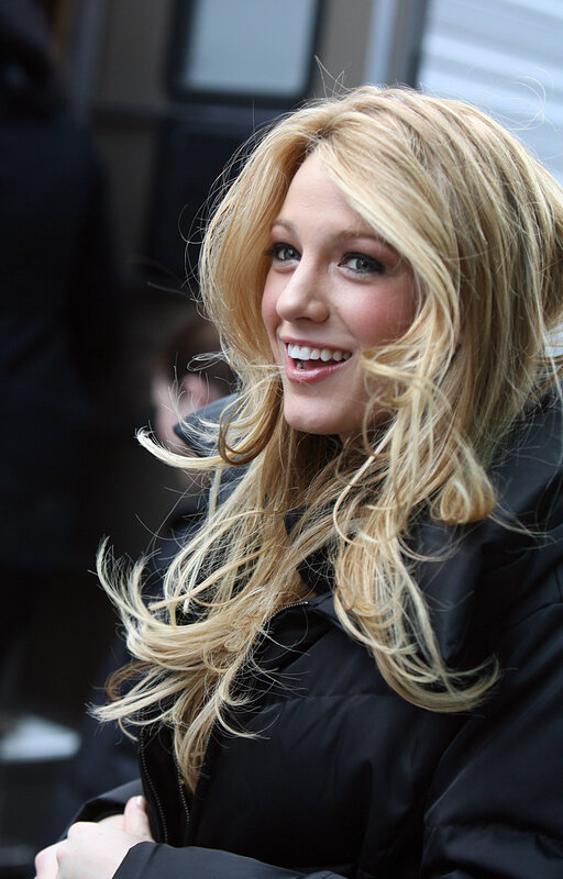 Blonde woman smiling outdoors