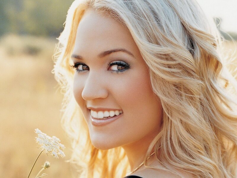 blonde woman smiling outdoors
