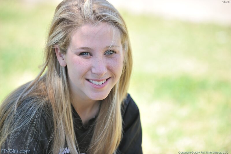 blonde woman smiling outdoors