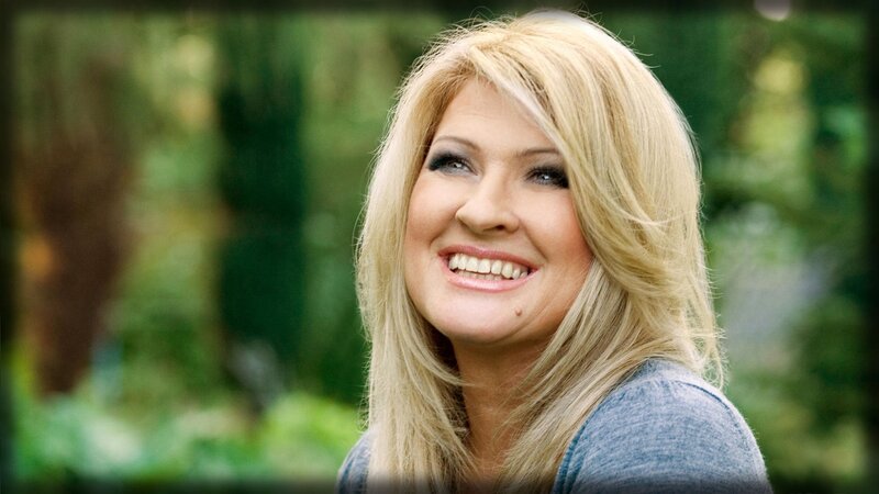 blonde woman smiling outdoors