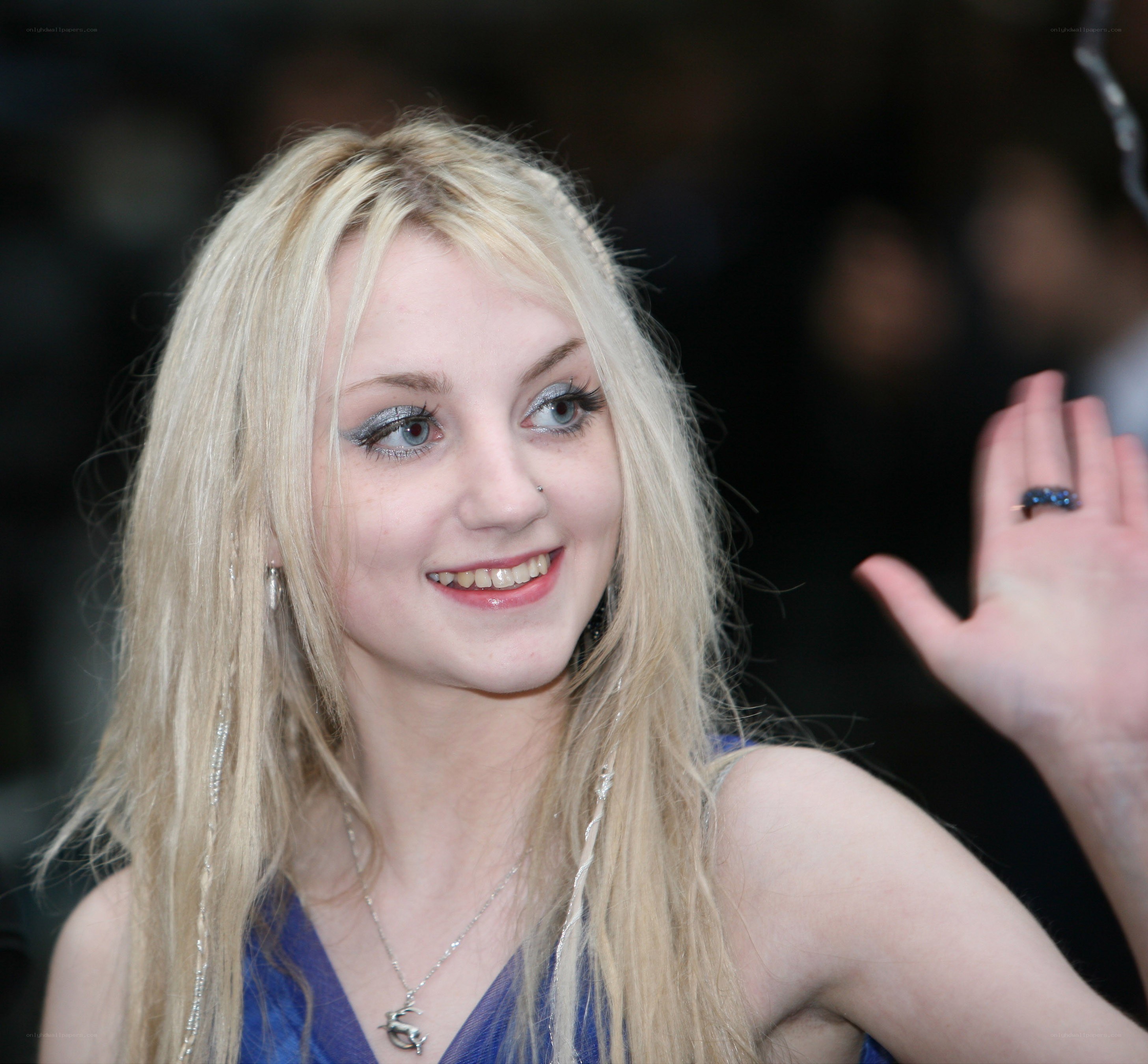 blonde woman waving