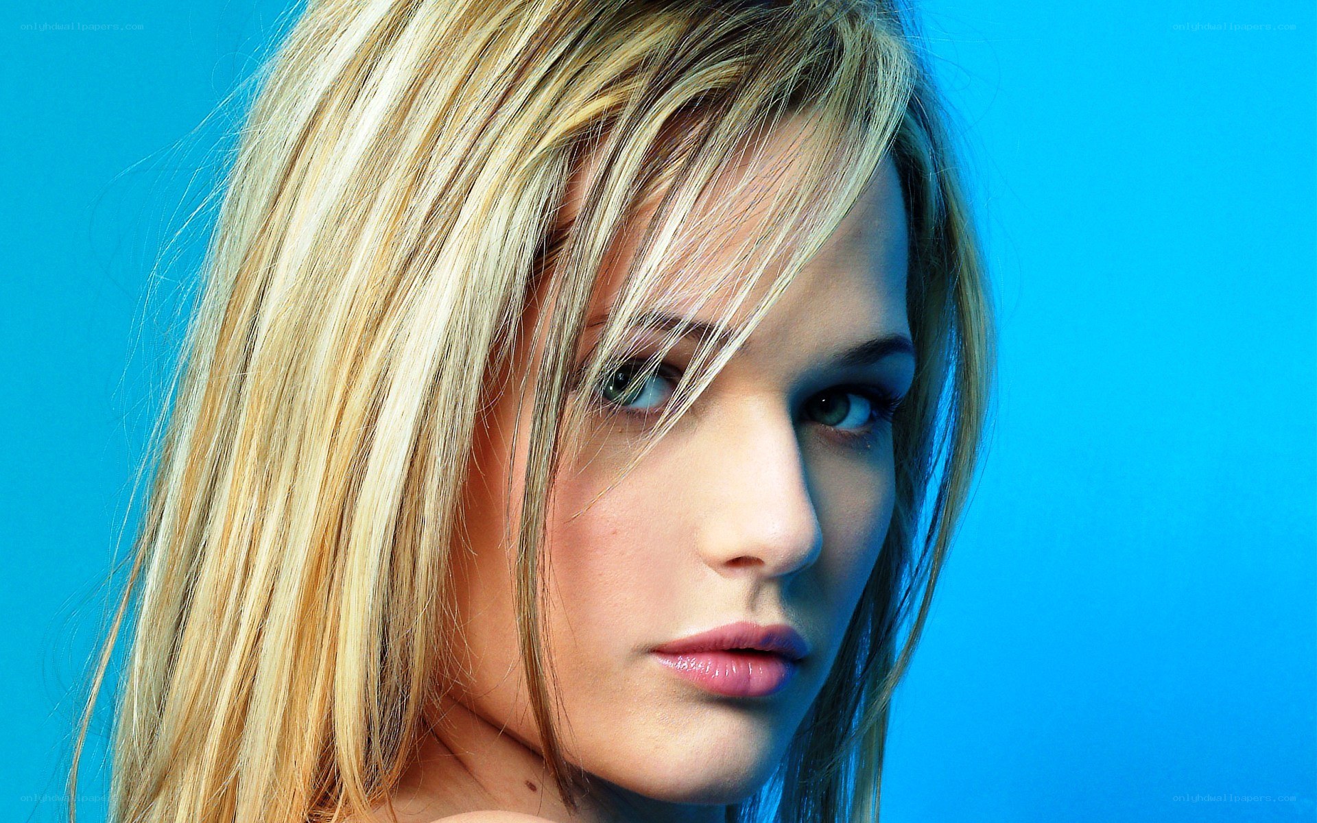 blonde woman with blue background