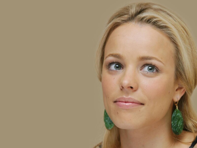 blonde woman with green earrings