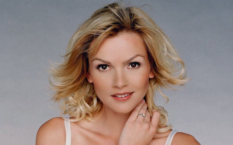 blonde woman with hand on neck