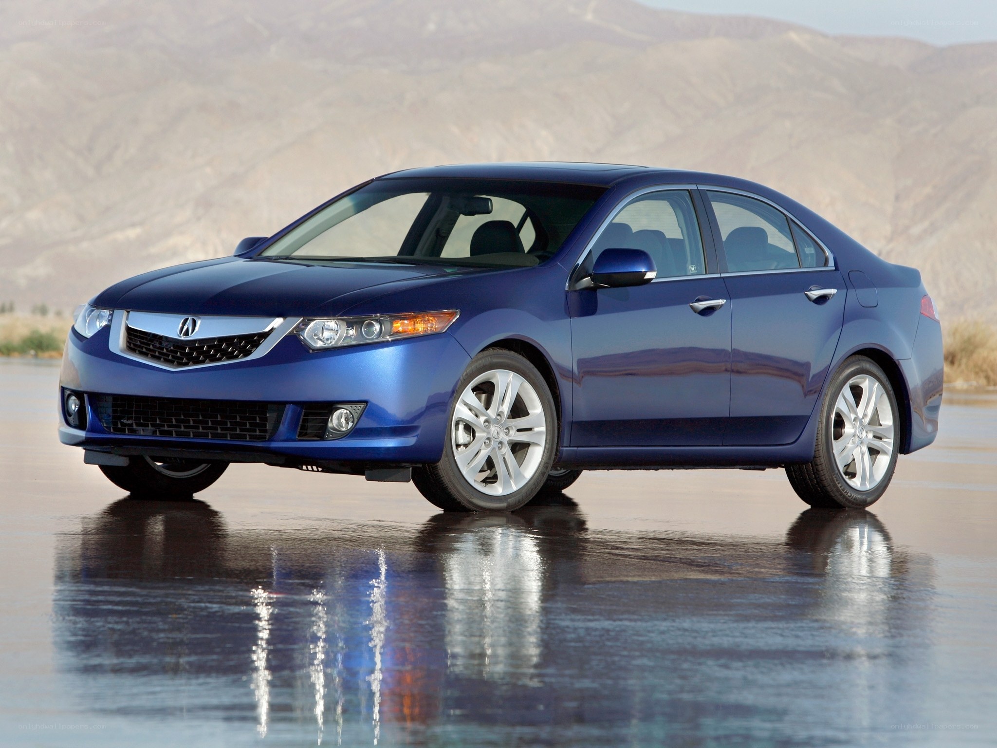 blue acura sedan on wet surface