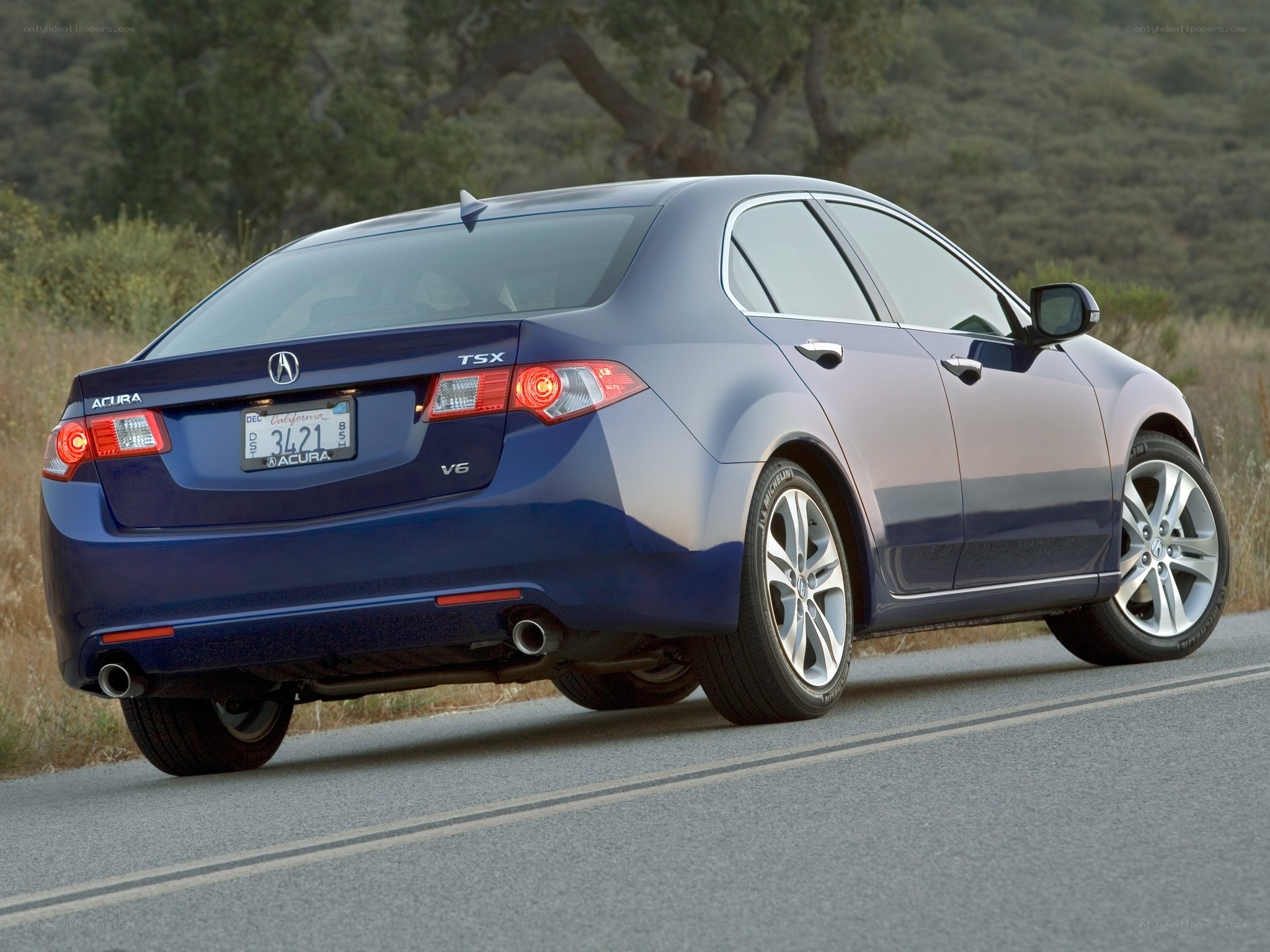 Blue Acura TSX on a road