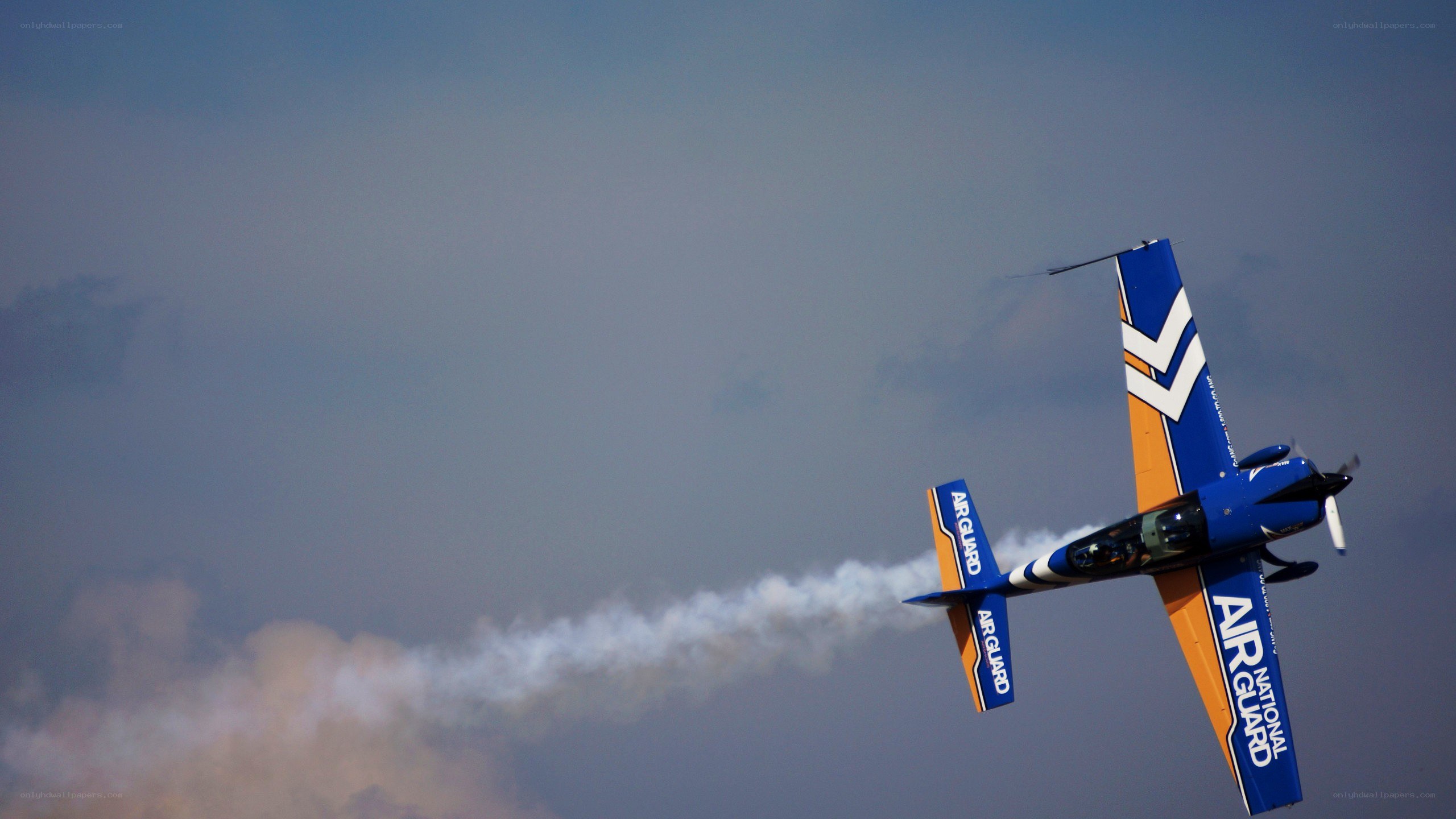 blue aerobatic plane in flight