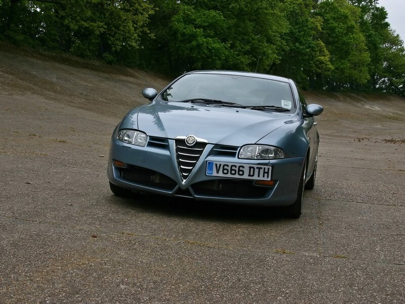 Blue Alfa Romeo on a road