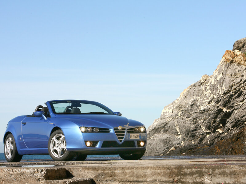 Blue Alfa Romeo Spider by the sea