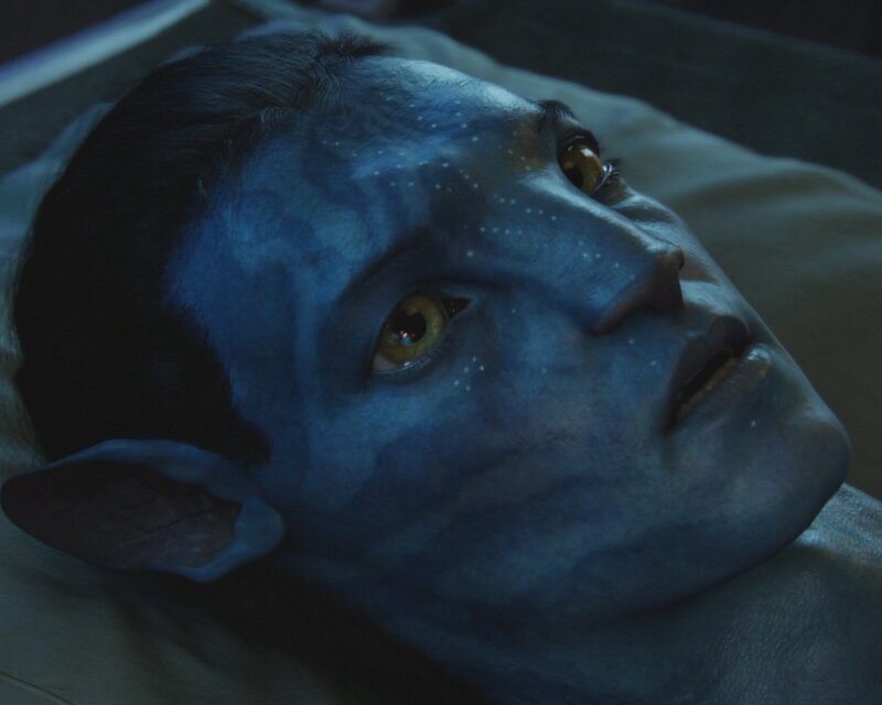 blue alien lying down