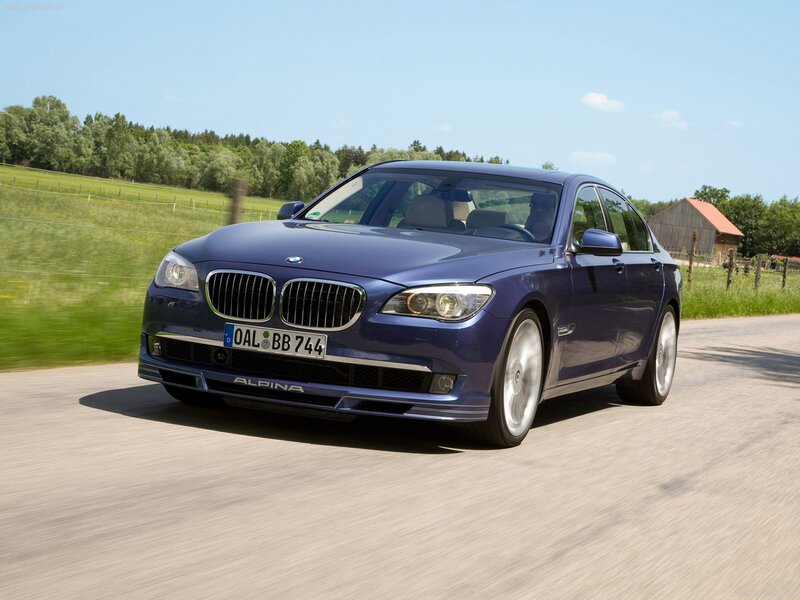 blue alpina-b7 driving on country road