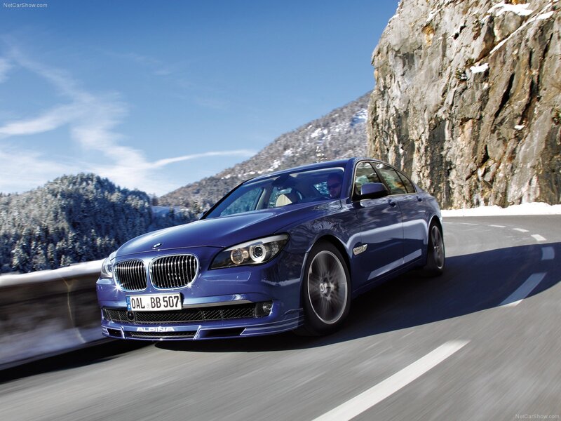 blue alpina-b7 driving on mountain road