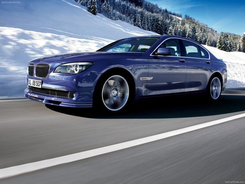blue alpina-b7 driving on snowy road