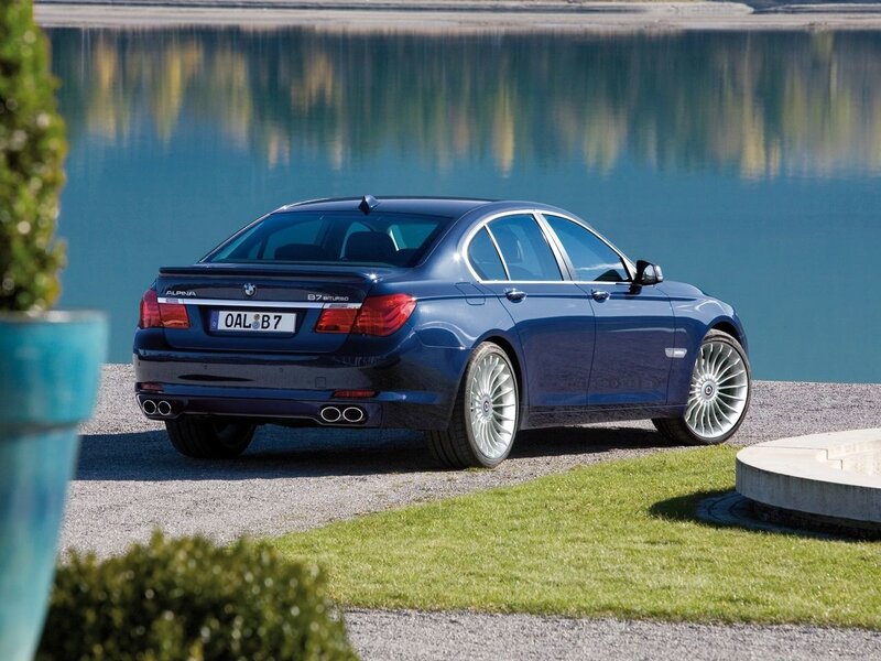 Blue Alpina B7 parked by lake