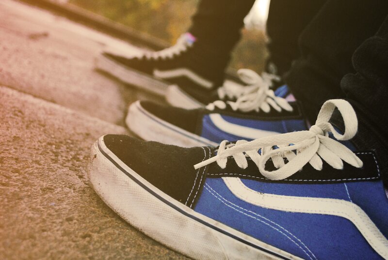 blue and black sneakers on pavement