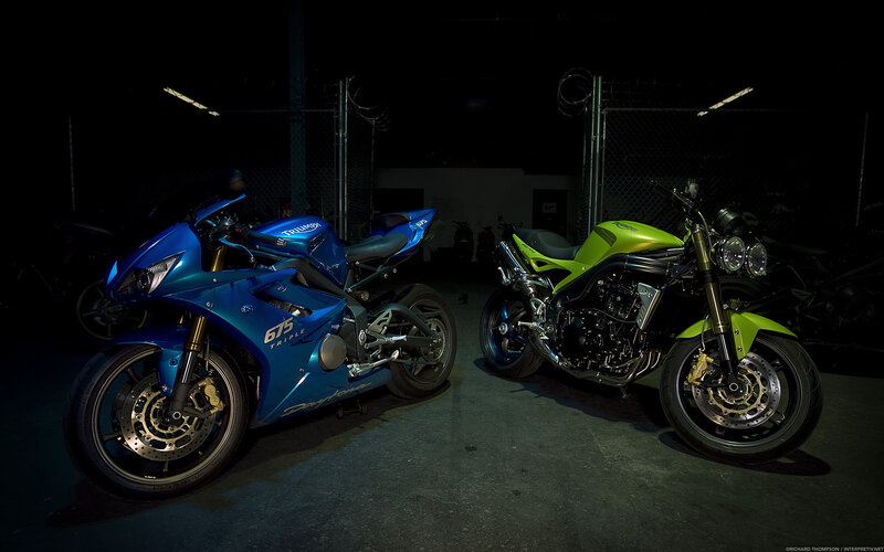 Blue and green motorcycles in garage