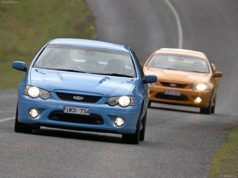 Blue and orange Ford Falcons on road