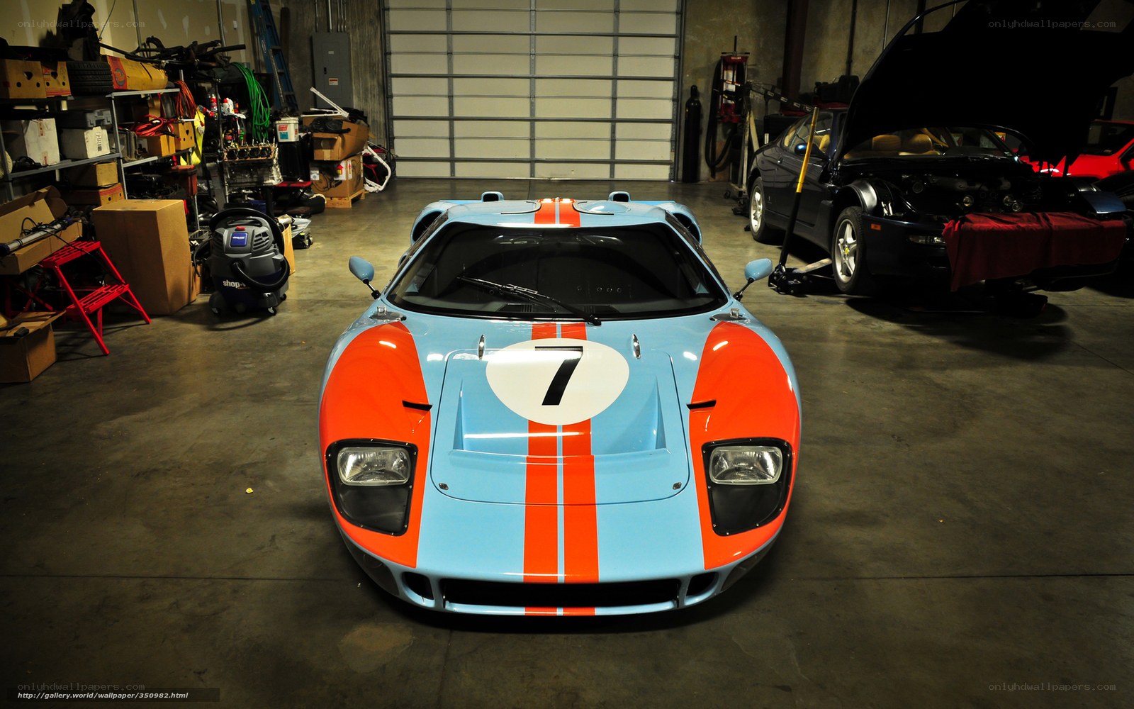 Blue and orange race car in garage