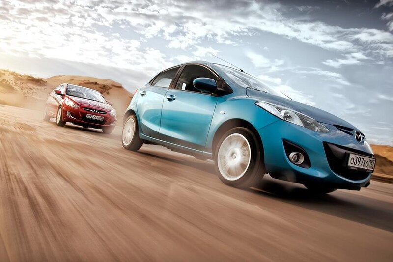 Blue and red cars racing on desert road