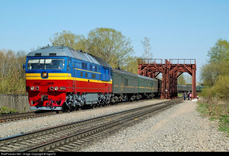 Blue and red locomotive on tracks