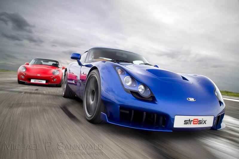 Blue and red sports cars racing