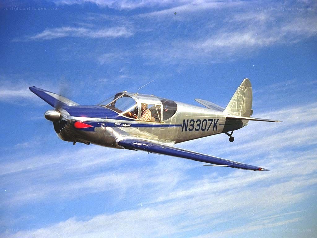 Blue and silver airplane in flight