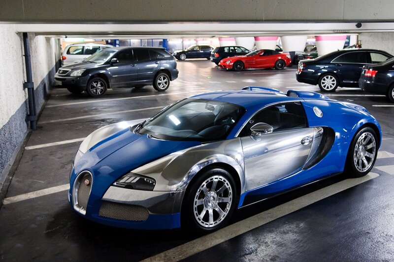 Blue and silver Bugatti in parking garage