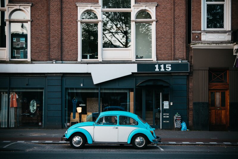 Blue and white Beetle car on street