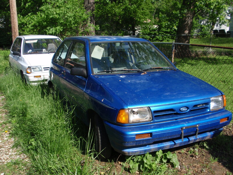 blue and white cars in grass