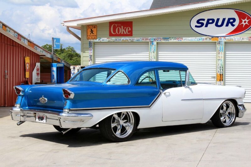 Blue and White Classic Car — Calm, Afternoon, Photograph, Building, Garage Doors